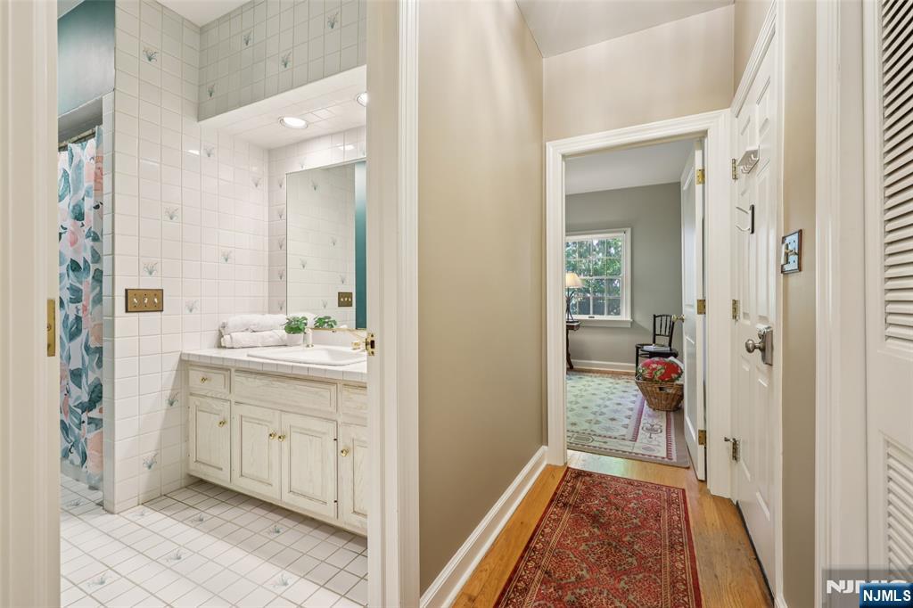 119 Sheridan Terrace Ridgewood, NJ 07450 - Photo 20 of 44 a bathroom with a sink and a mirror