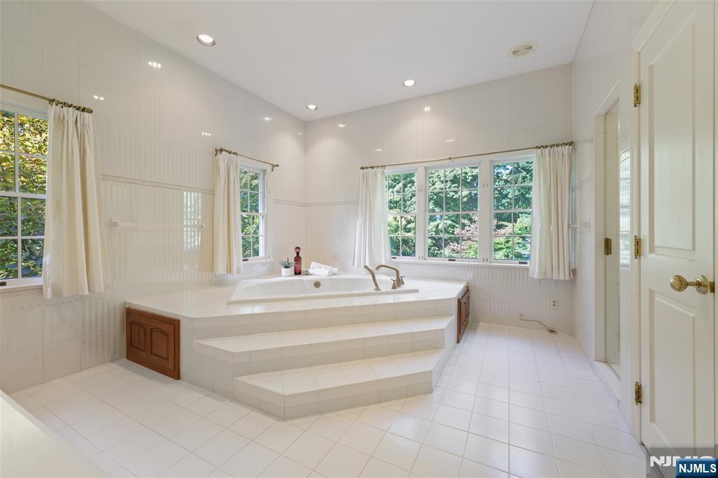 119 Sheridan Terrace Ridgewood, NJ 07450 - Photo 27 of 44 a spacious bathroom with a large tub and shower