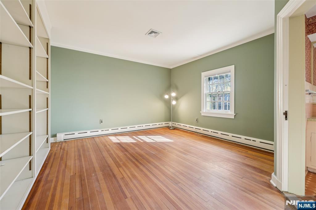119 Sheridan Terrace Ridgewood, NJ 07450 - Photo 29 of 44 an empty room with wooden floor and windows