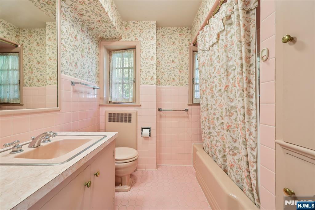 119 Sheridan Terrace Ridgewood, NJ 07450 - Photo 33 of 44 a bathroom with a sink a toilet a window and a shower