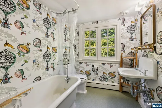 a bathroom with a bathtub a sink and a window