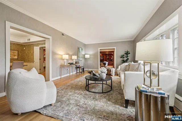 a living room with furniture a dining table and a large window