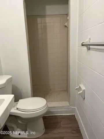 a bathroom with a toilet and a shower