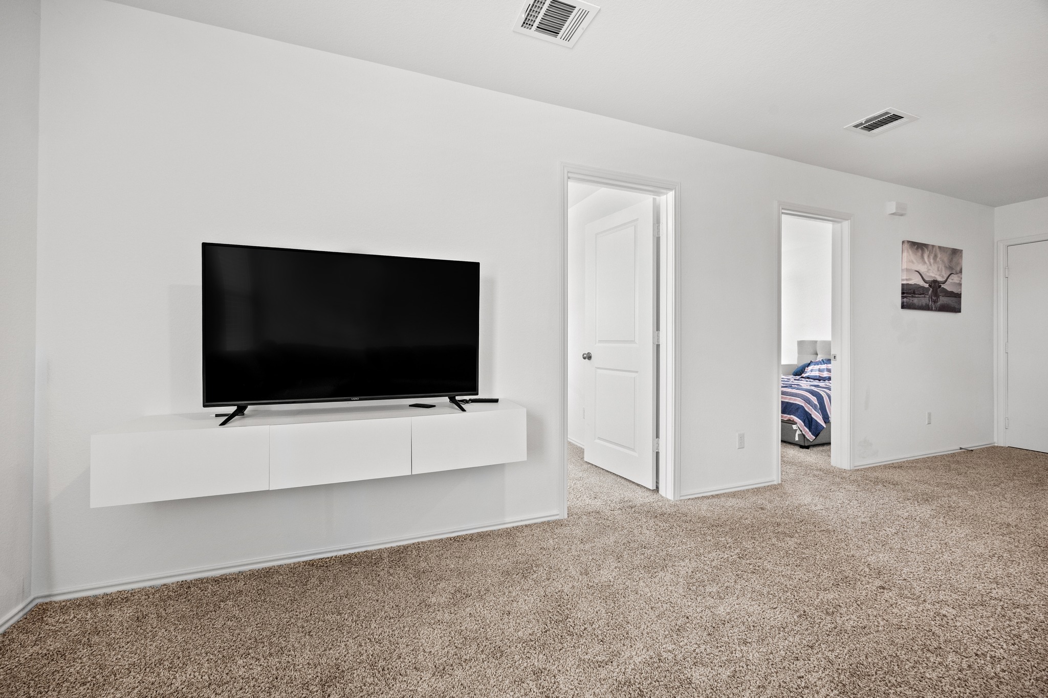 14121 Berning Road Manor, TX 78653 - Photo 16 of 27 A well-lit interior space with plush carpeting, offering a cozy and comfortable living environment.