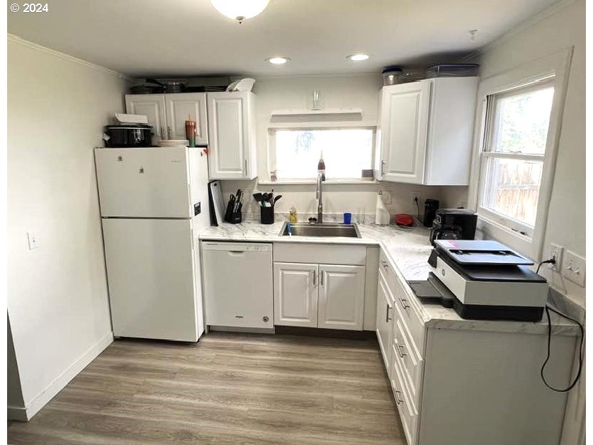 826 Southeast 8th Street Pendleton, OR 97801 - Photo 11 of 13 a kitchen with white cabinets and white appliances