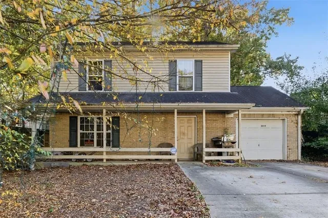 front view of a house with a bench and a window