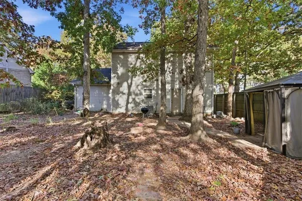 a backyard of a house with barbeque oven and outdoor seating