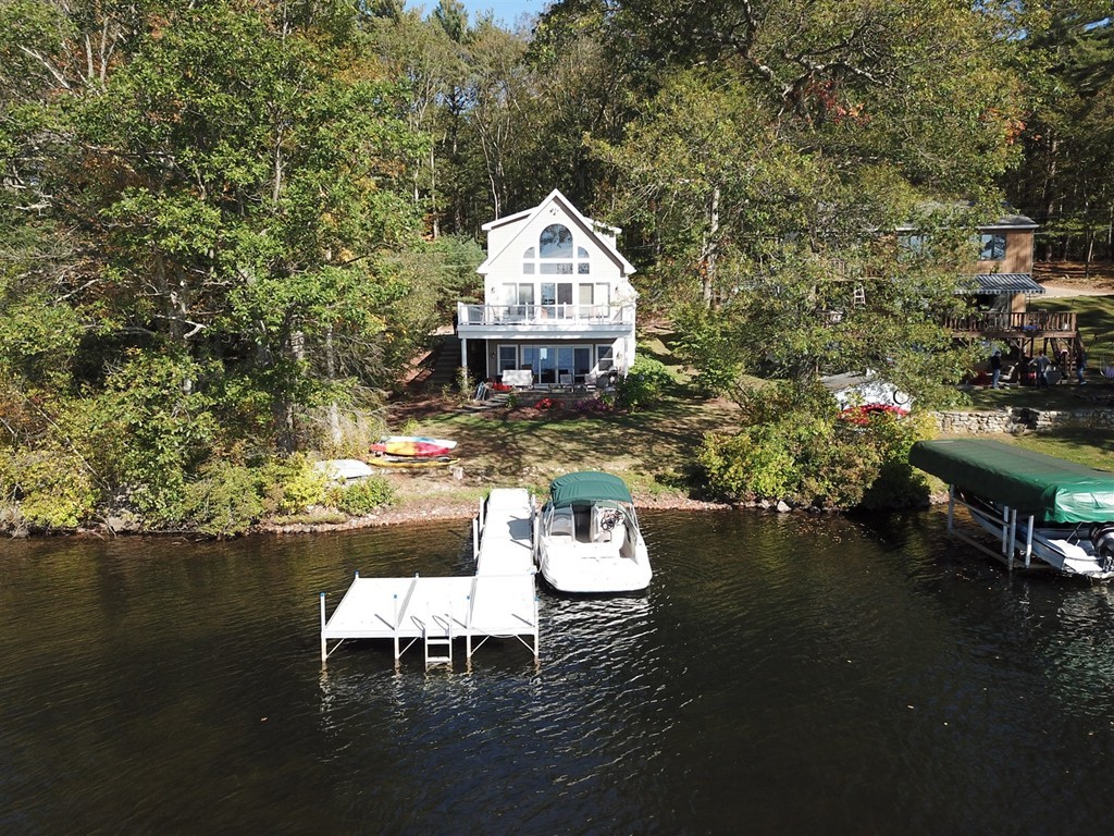 8 Reid Smith Cove Road Webster, MA 01570 - Photo 5 of 30 a roof deck with table and chairs and potted plants