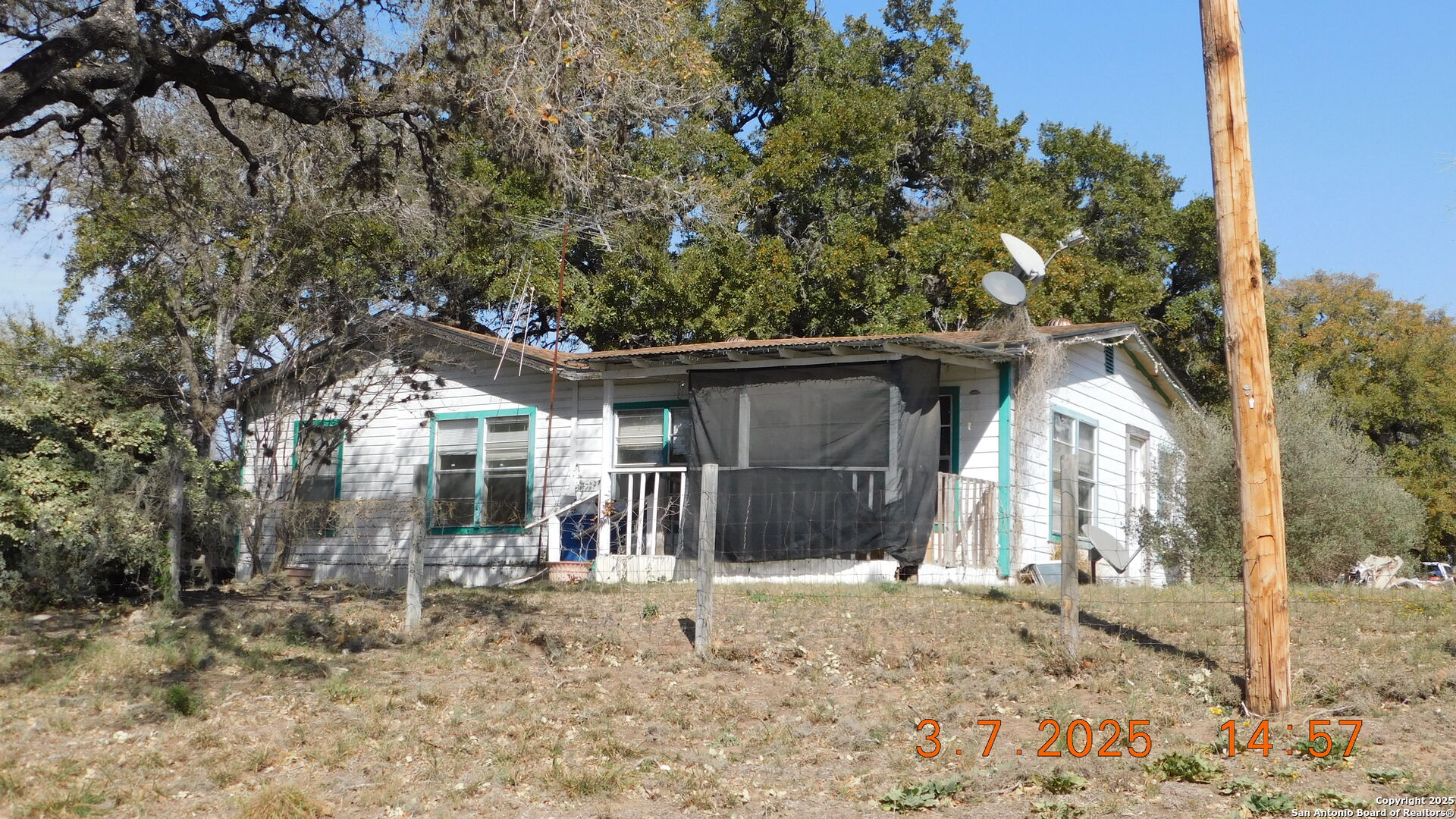 210 Colwell Avenue Pleasanton, TX 78064 - Photo 2 of 14 a front view of a house with a yard and garage