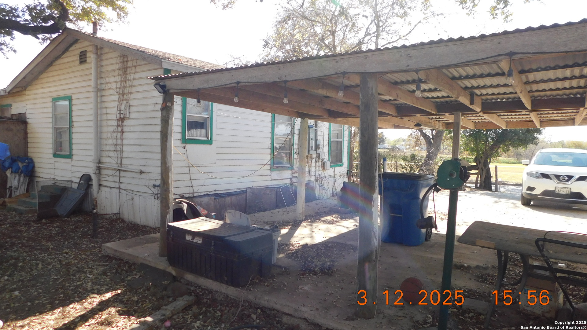 210 Colwell Avenue Pleasanton, TX 78064 - Photo 7 of 14 a view of a patio with table and chairs and potted plants
