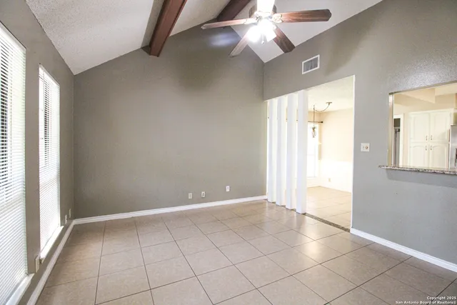 a view of an empty room with a window