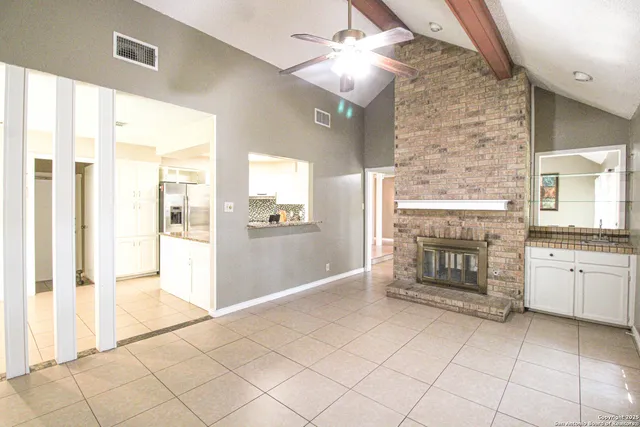 a spacious bathroom with a granite countertop sink a mirror and a shower