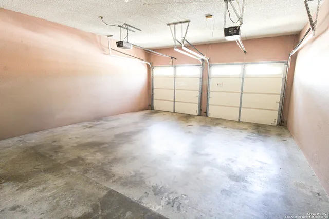 a view of a backyard with tree and wooden fence