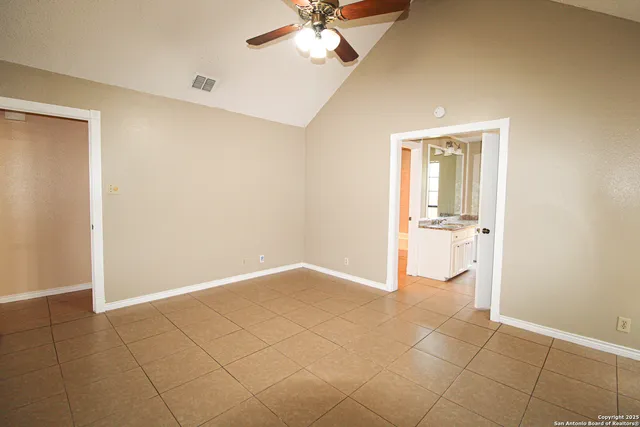 a view of a cabinet and a chandelier fan in a room