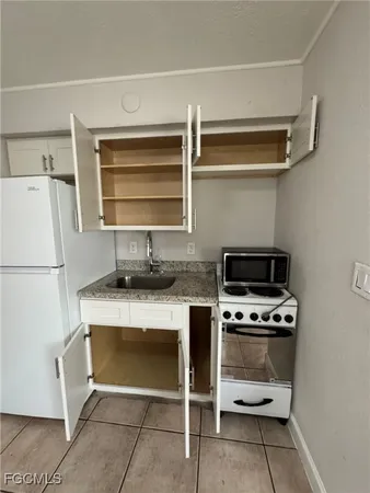 a kitchen with a stove and a refrigerator