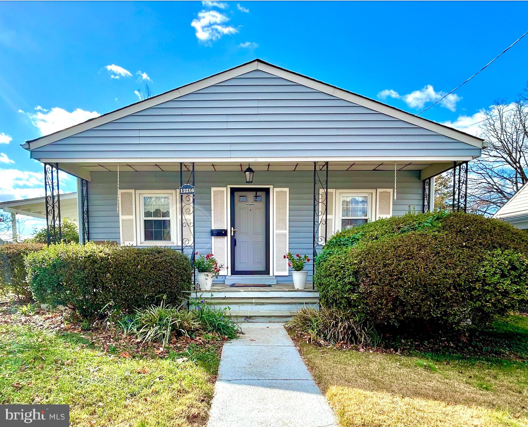 12216 Charles Road Silver Spring, MD 20906 - Photo 1 of 23 a front view of a house with garden