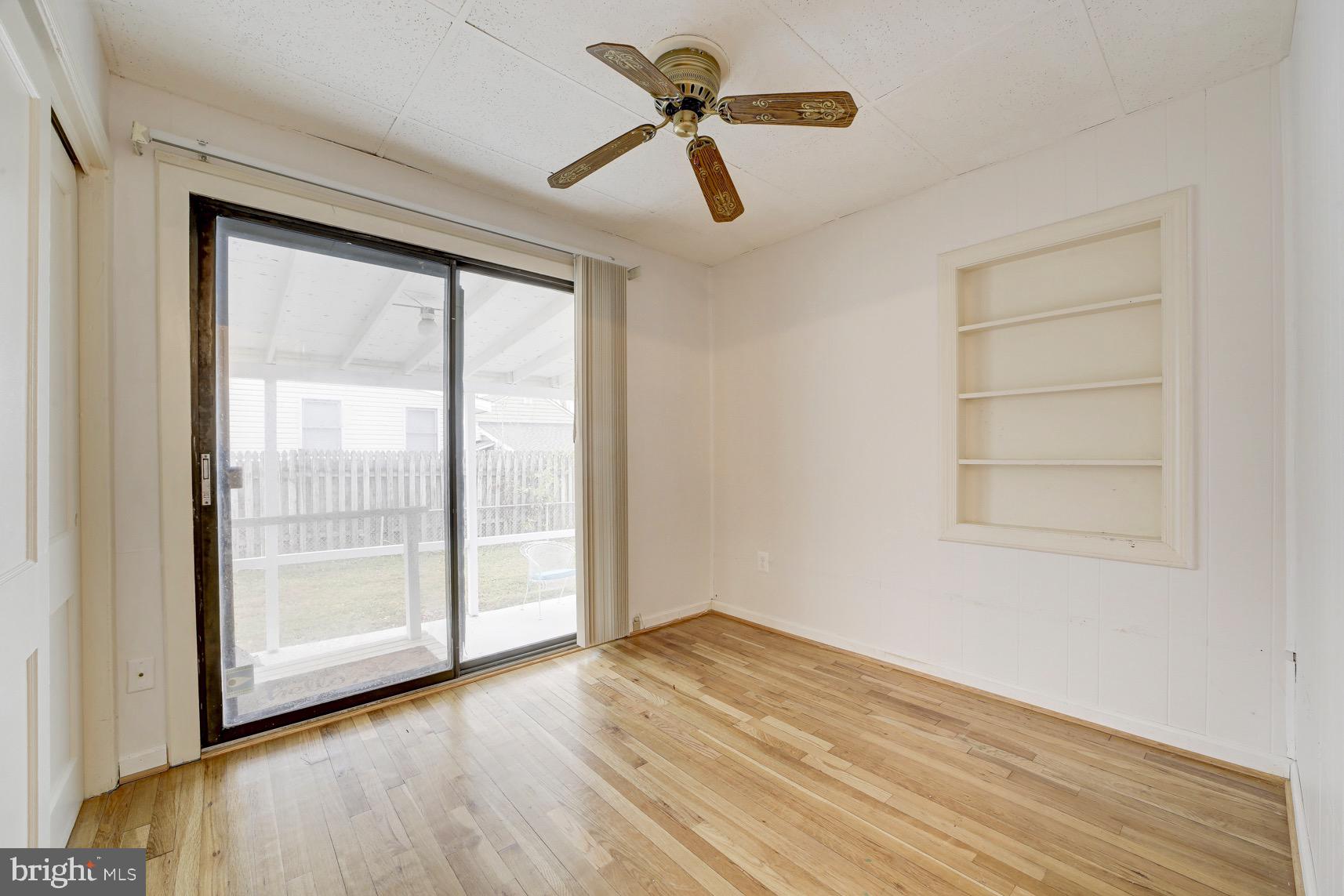 12216 Charles Road Silver Spring, MD 20906 - Photo 11 of 22 wooden floor in an empty room with a window