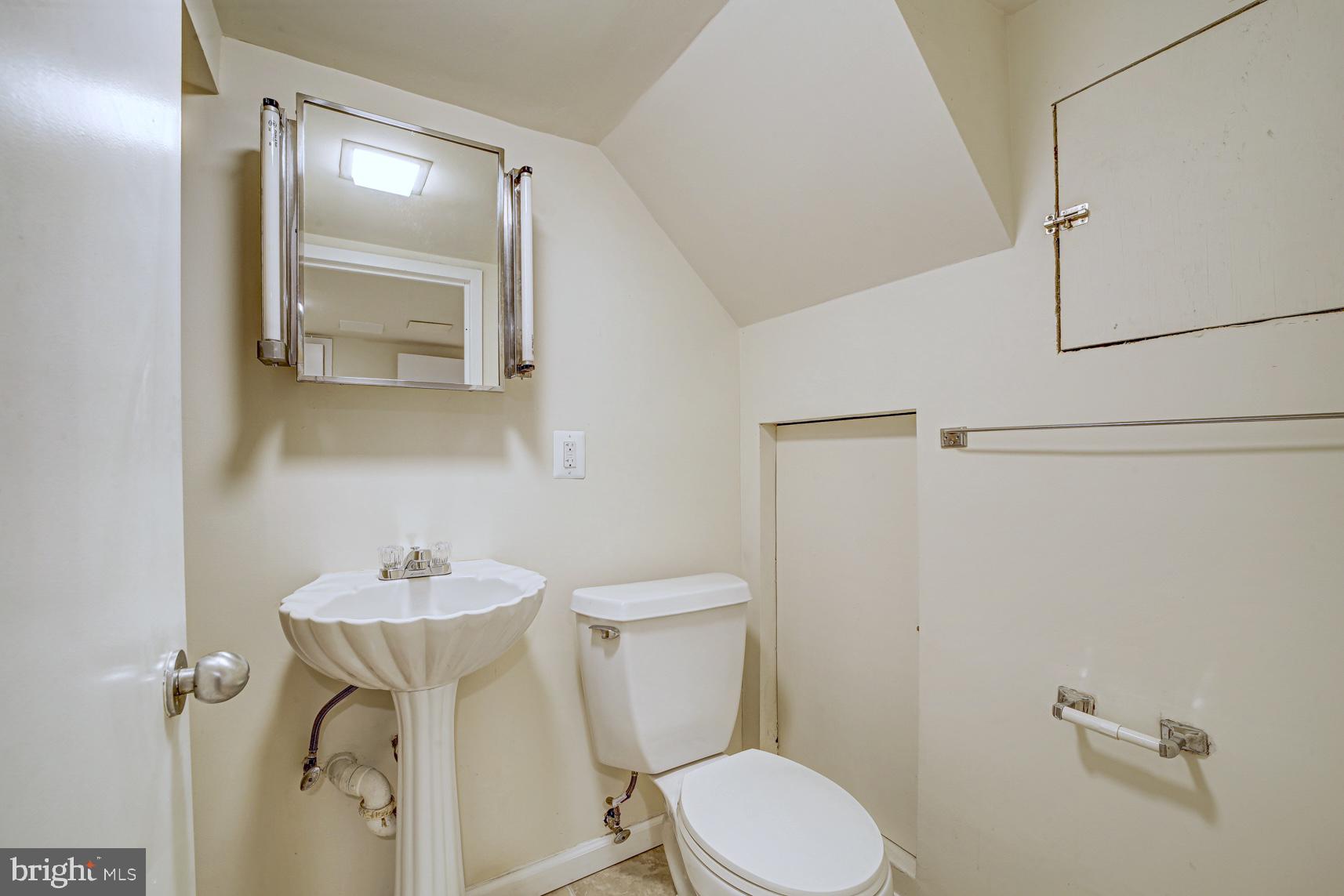 12216 Charles Road Silver Spring, MD 20906 - Photo 17 of 22 a bathroom with a sink a toilet and mirror