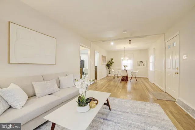 a living room with furniture a lamp and a table