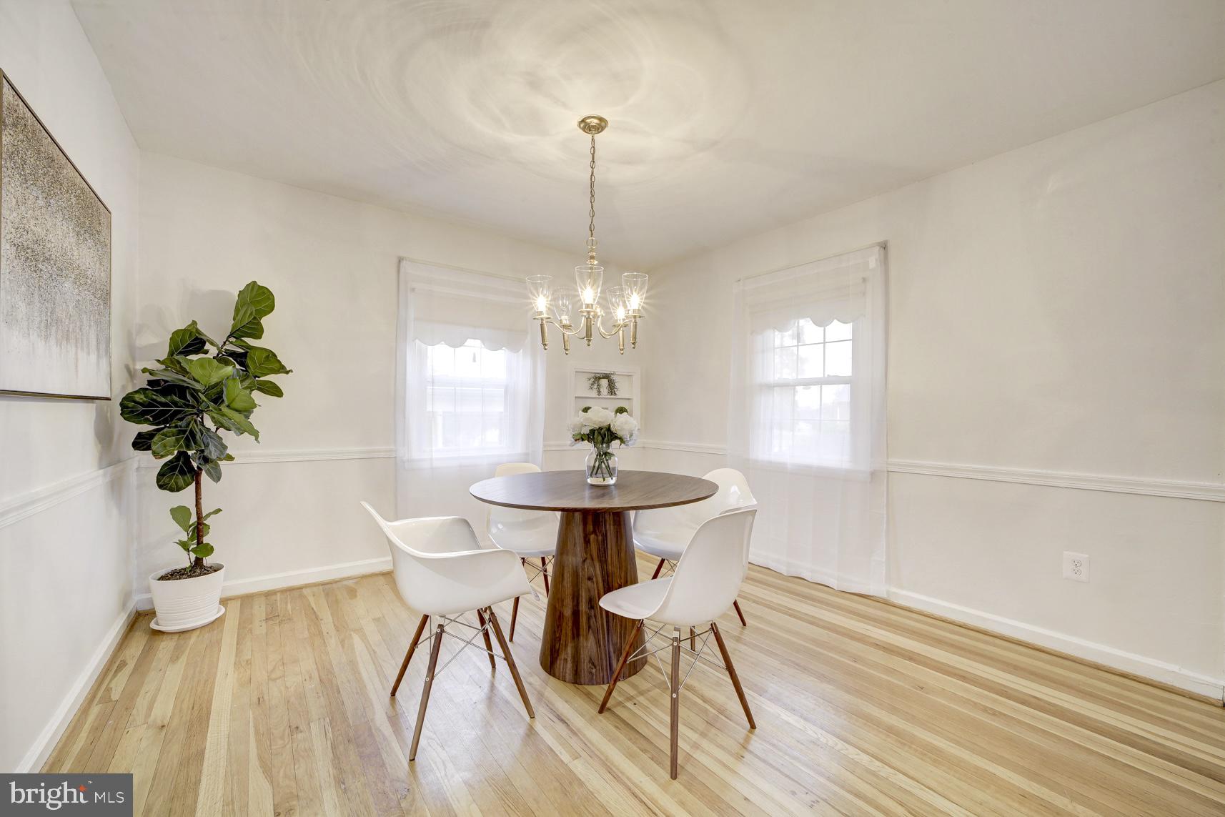 12216 Charles Road Silver Spring, MD 20906 - Photo 7 of 22 a dining room with chandelier and wooden floor