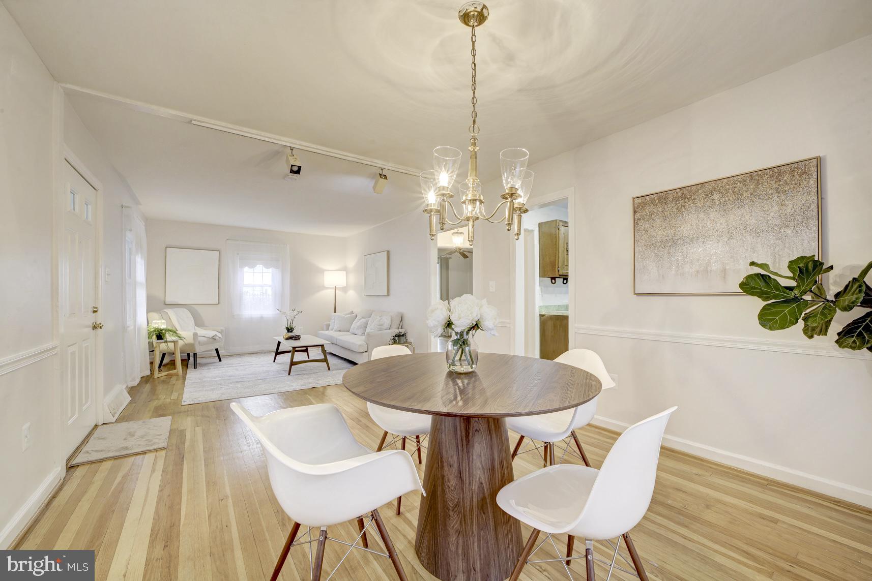 12216 Charles Road Silver Spring, MD 20906 - Photo 8 of 22 a dining room with furniture and wooden floor