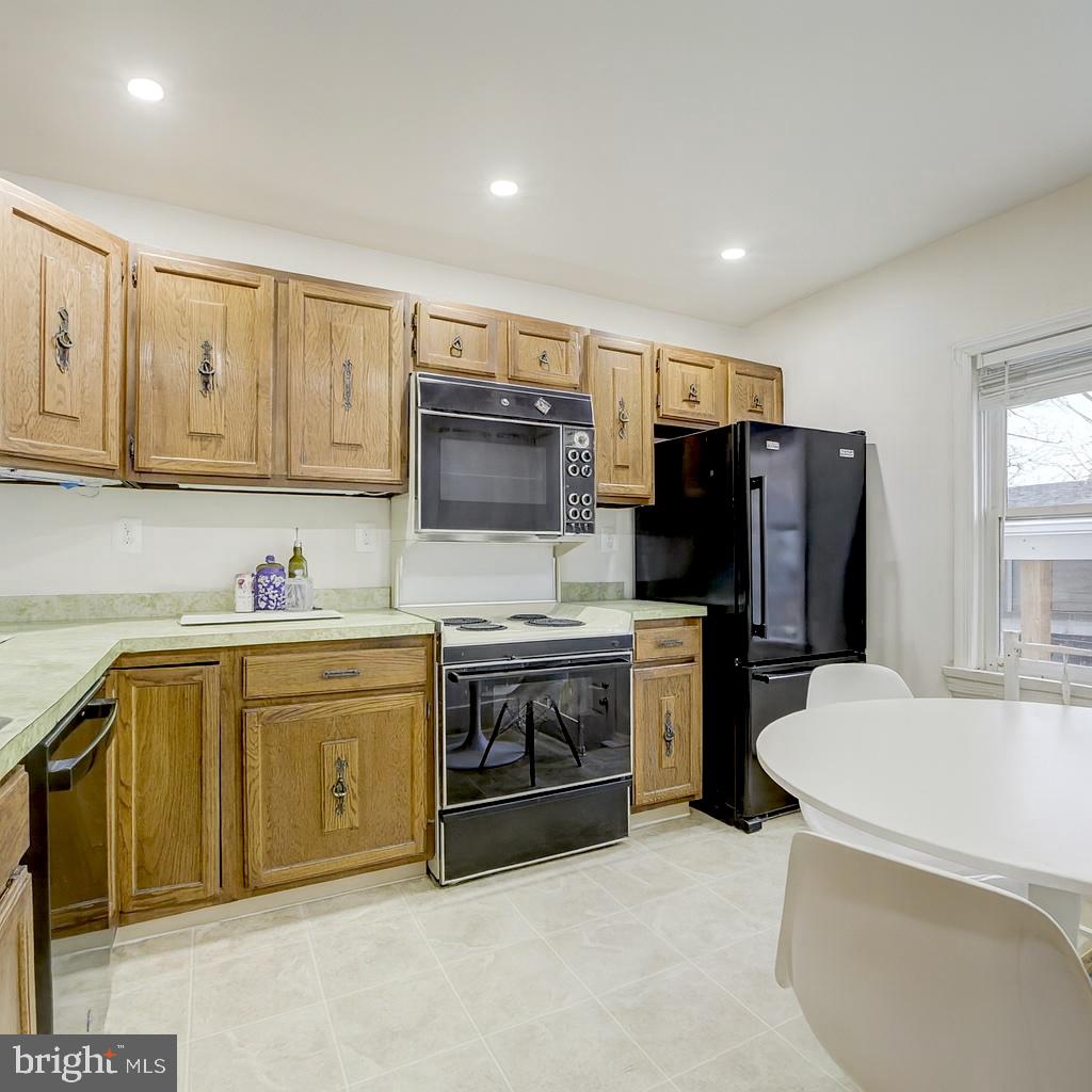 12216 Charles Road Silver Spring, MD 20906 - Photo 10 of 22 a kitchen with stainless steel appliances granite countertop a refrigerator sink and stove