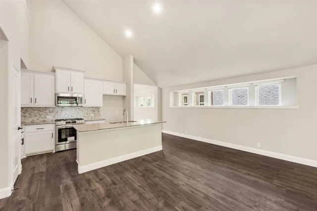 a kitchen with wooden floors and white appliances