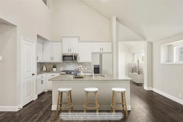 a view of kitchen with refrigerator stove microwave and cabinets