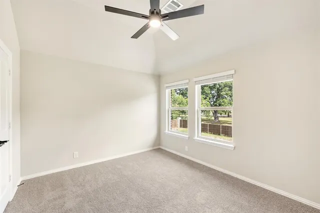 a bathroom with a granite countertop sink mirror vanity and toilet
