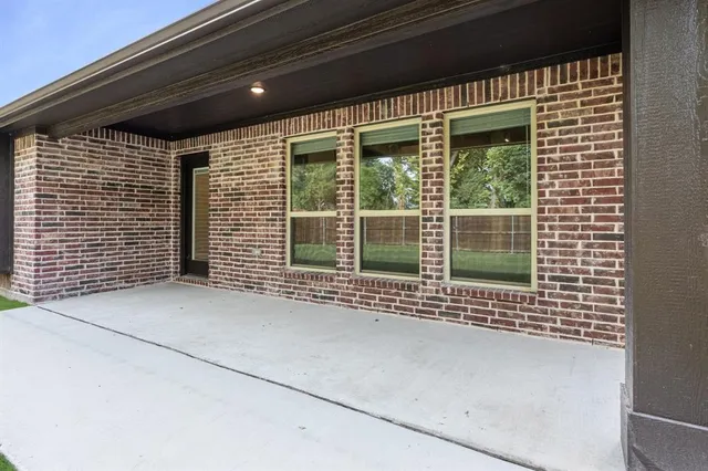 a view of yard and trees in the background
