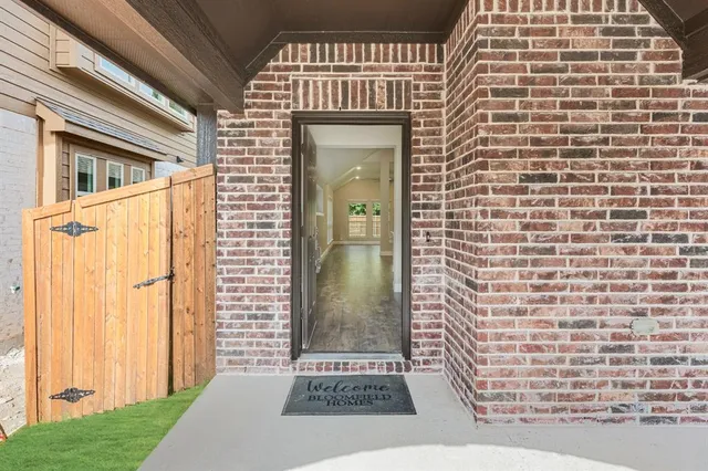 a view of a brick house with a door and wooden floor