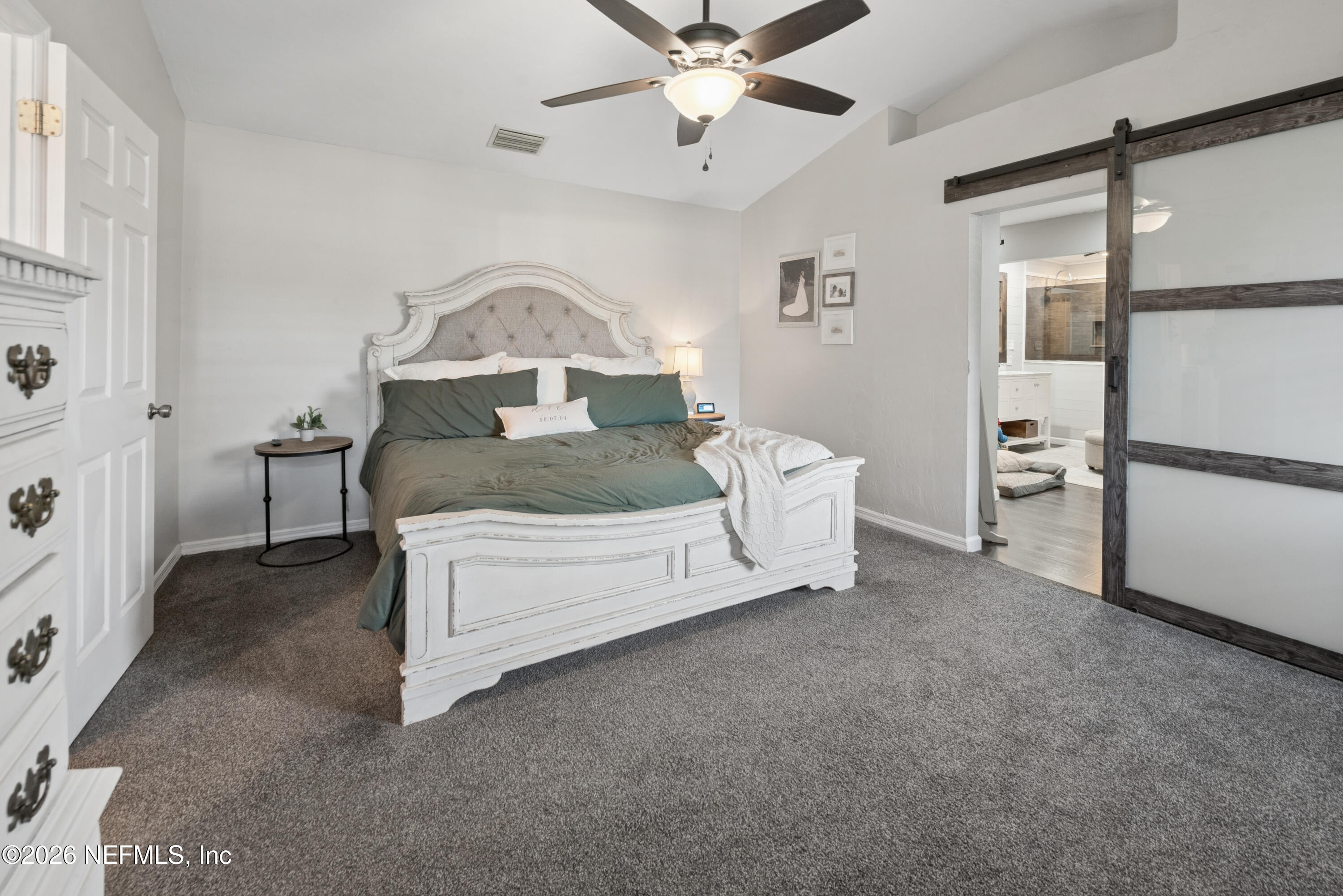 1659 Highway 230 Starke, FL 32091 - Photo 19 of 48 a spacious bedroom with a bed and a chandelier