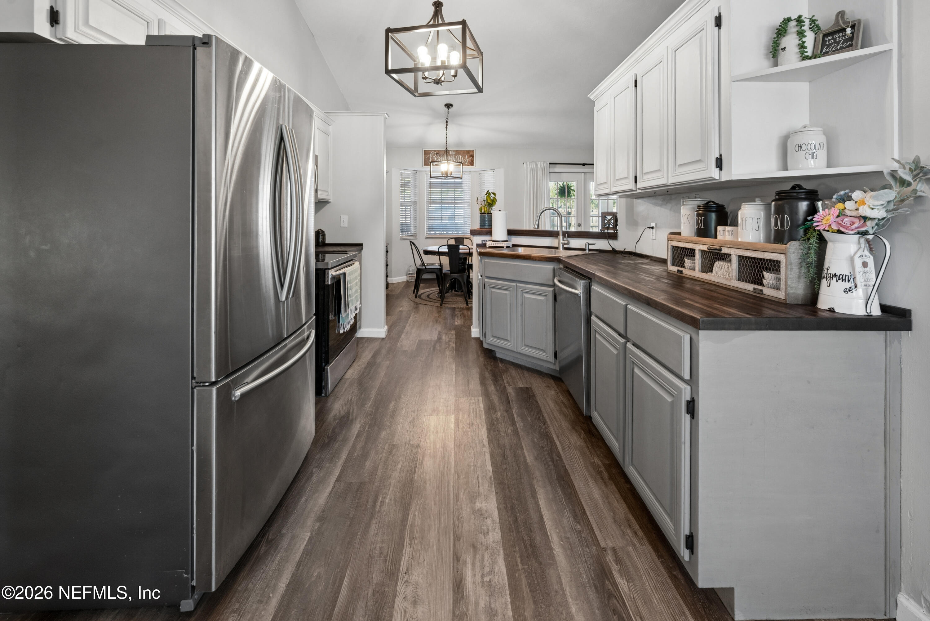 1659 Highway 230 Starke, FL 32091 - Photo 8 of 48 a kitchen with stainless steel appliances granite countertop a refrigerator a sink dishwasher a stove and white countertops with wooden floor
