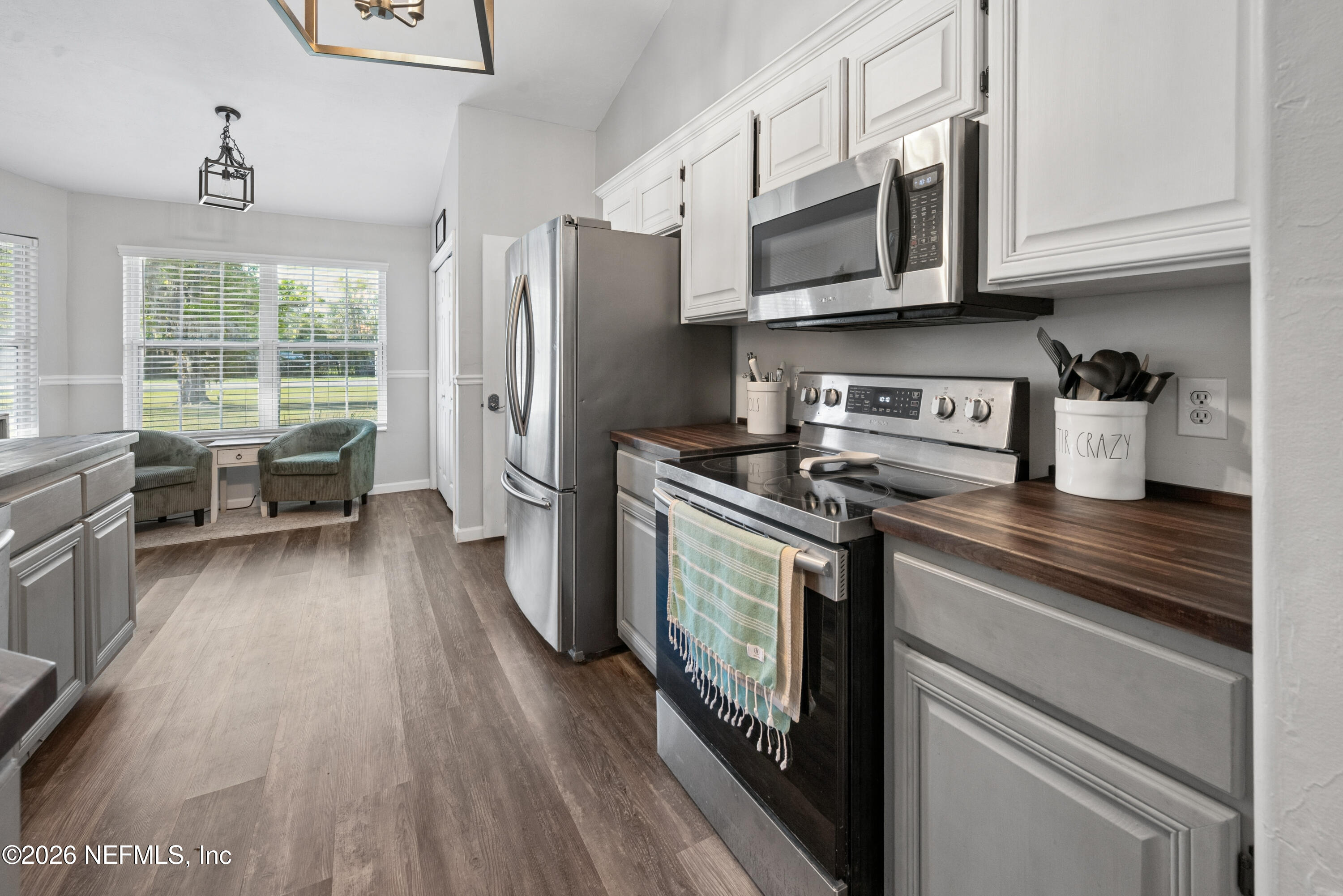 1659 Highway 230 Starke, FL 32091 - Photo 10 of 48 a kitchen with stainless steel appliances a stove a sink dishwasher a microwave oven with cabinets and wooden floor