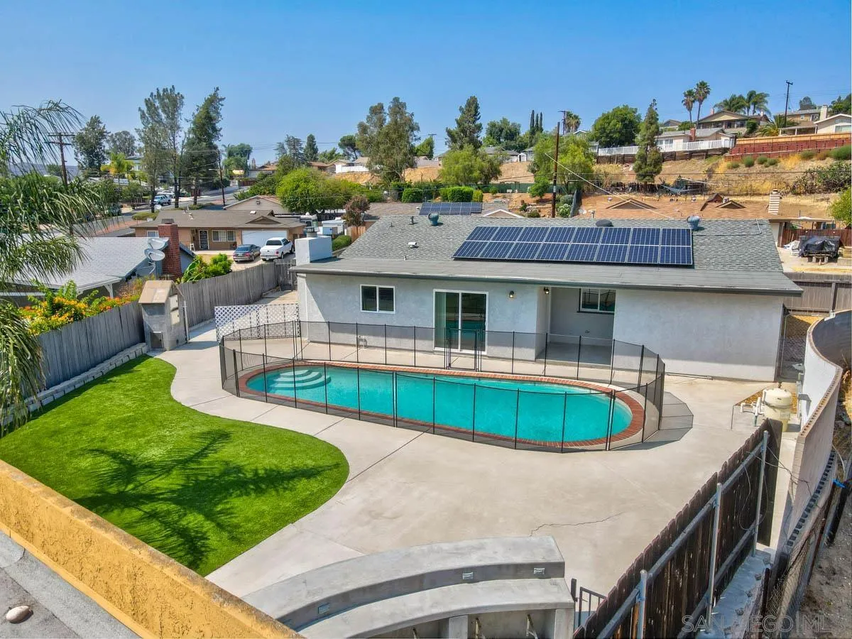 9762 Domer Road Santee, CA 92071 - Photo 3 of 34 a front view of a house with a garden and swimming pool