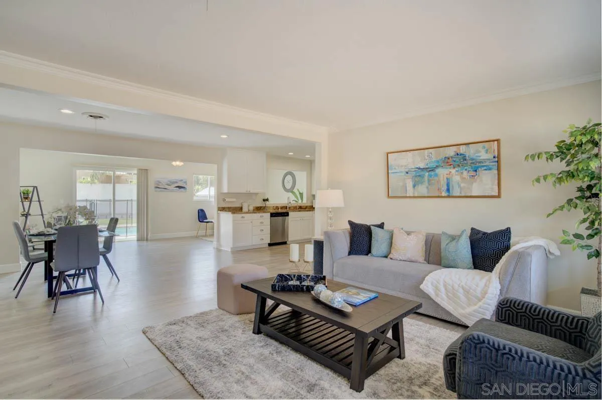 9762 Domer Road Santee, CA 92071 - Photo 4 of 34 a living room with furniture and a dining table with wooden floor