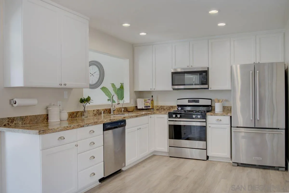9762 Domer Road Santee, CA 92071 - Photo 5 of 34 a kitchen with granite countertop a refrigerator stove and sink