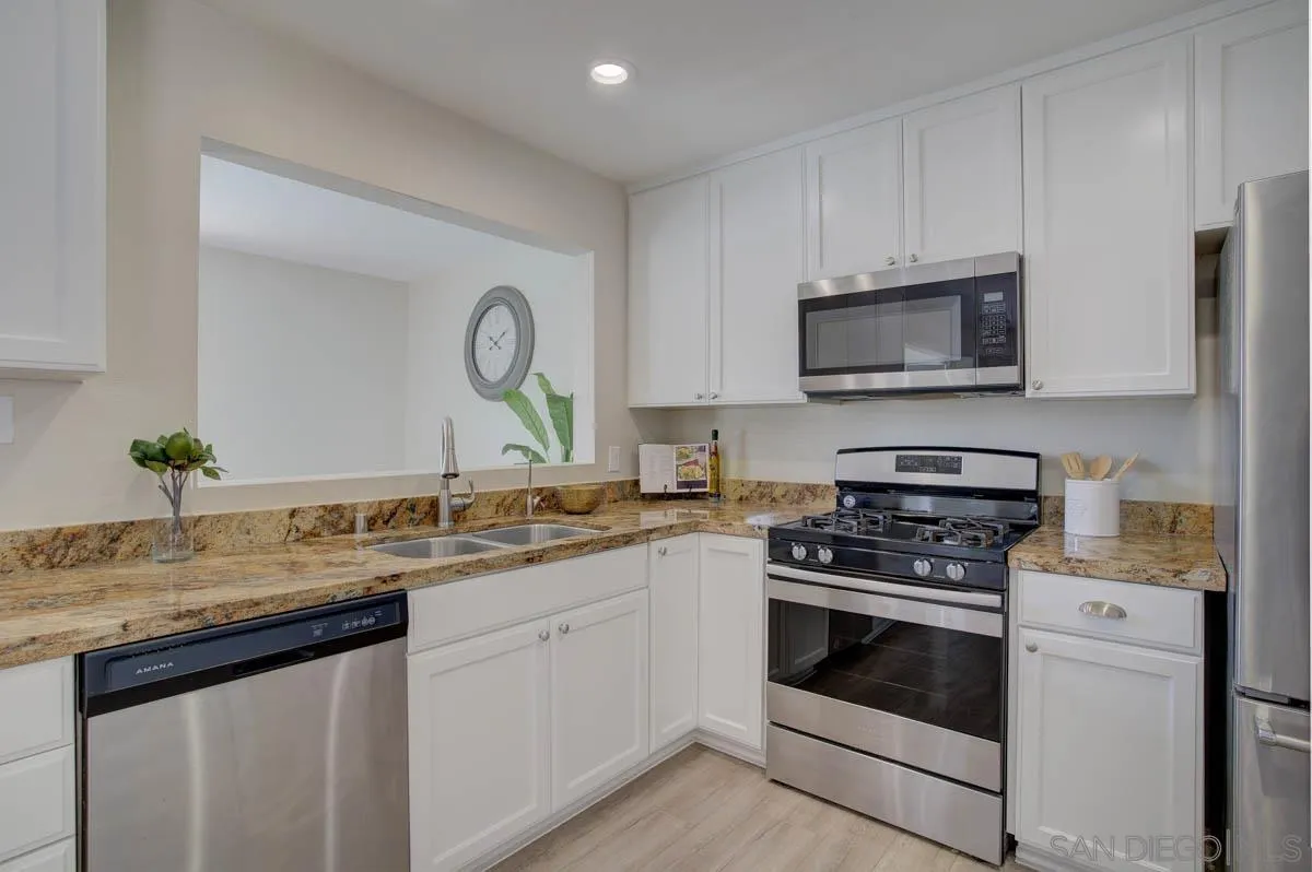 9762 Domer Road Santee, CA 92071 - Photo 6 of 34 a kitchen with a sink stove and microwave