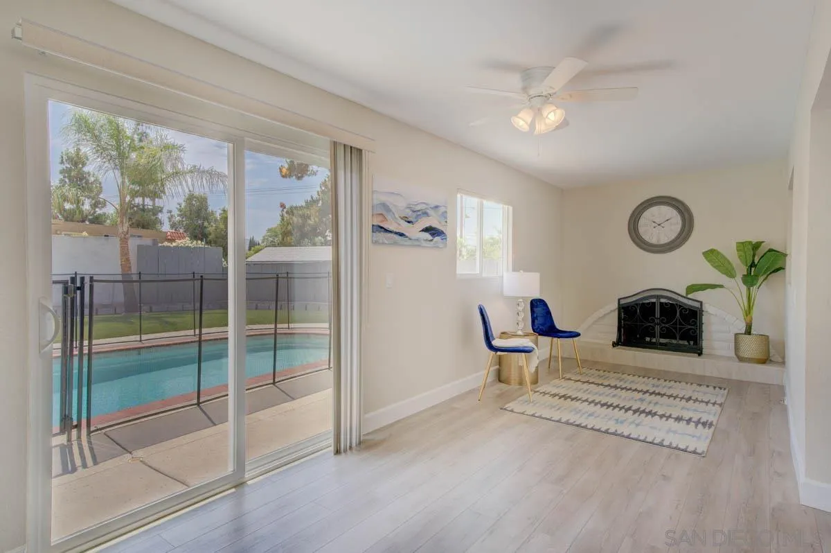 9762 Domer Road Santee, CA 92071 - Photo 9 of 34 a living room with couch and a clock on the wall