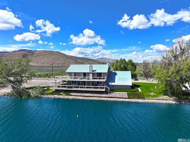 a view of a swimming pool with an outdoor seating and deck in the back