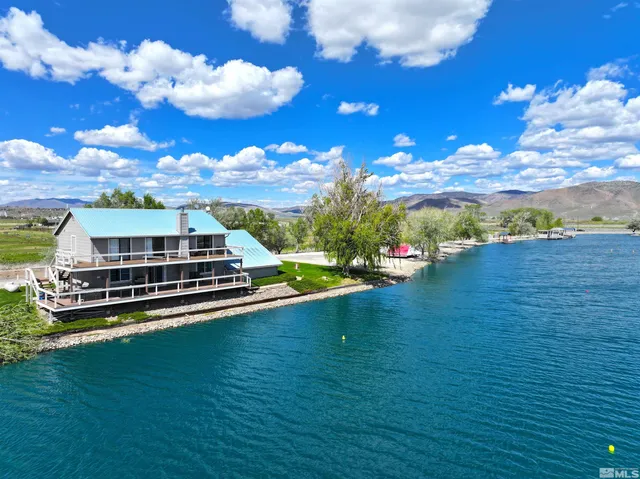 a view of a city with lots of residential buildings ocean and mountain view in back