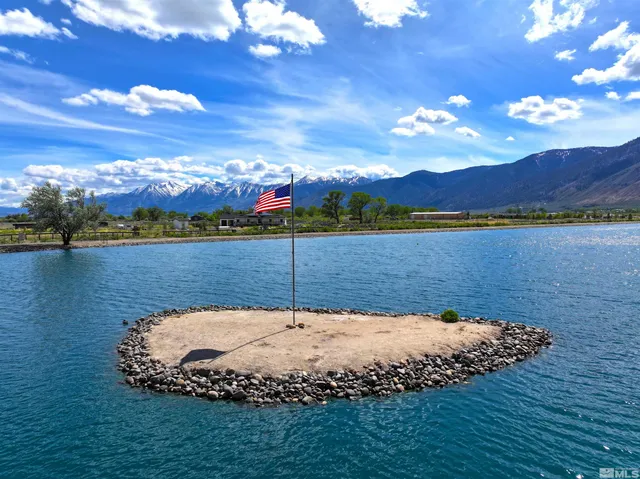 a view of a swimming pool with a lake view and mountain view