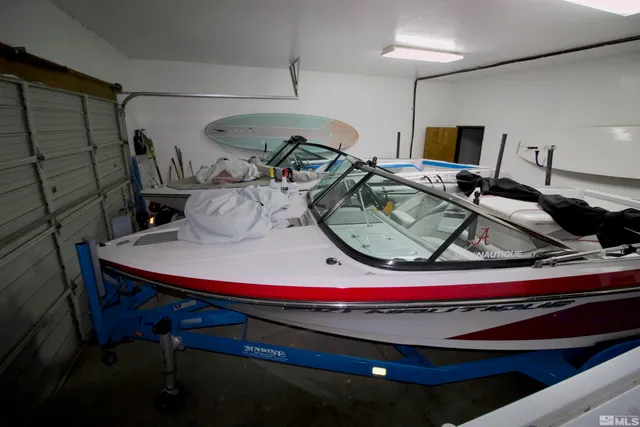 a kitchen with granite countertop a sink cabinets and wooden floor