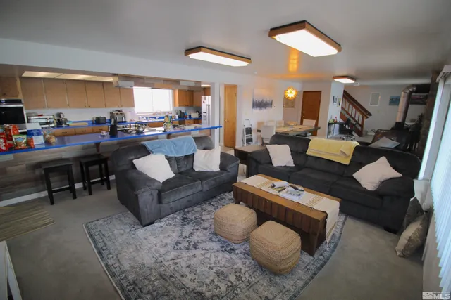 a view of a dining room with furniture and a chandelier