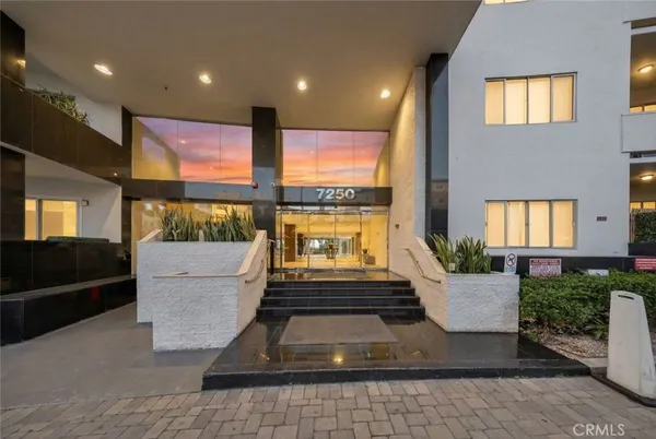 a view of a cars park in front of a building