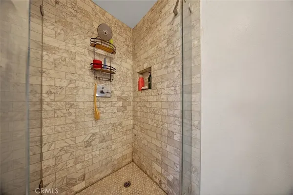 a living room with fireplace furniture and a large window