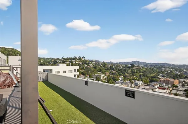 a view of parking garage with cars parked