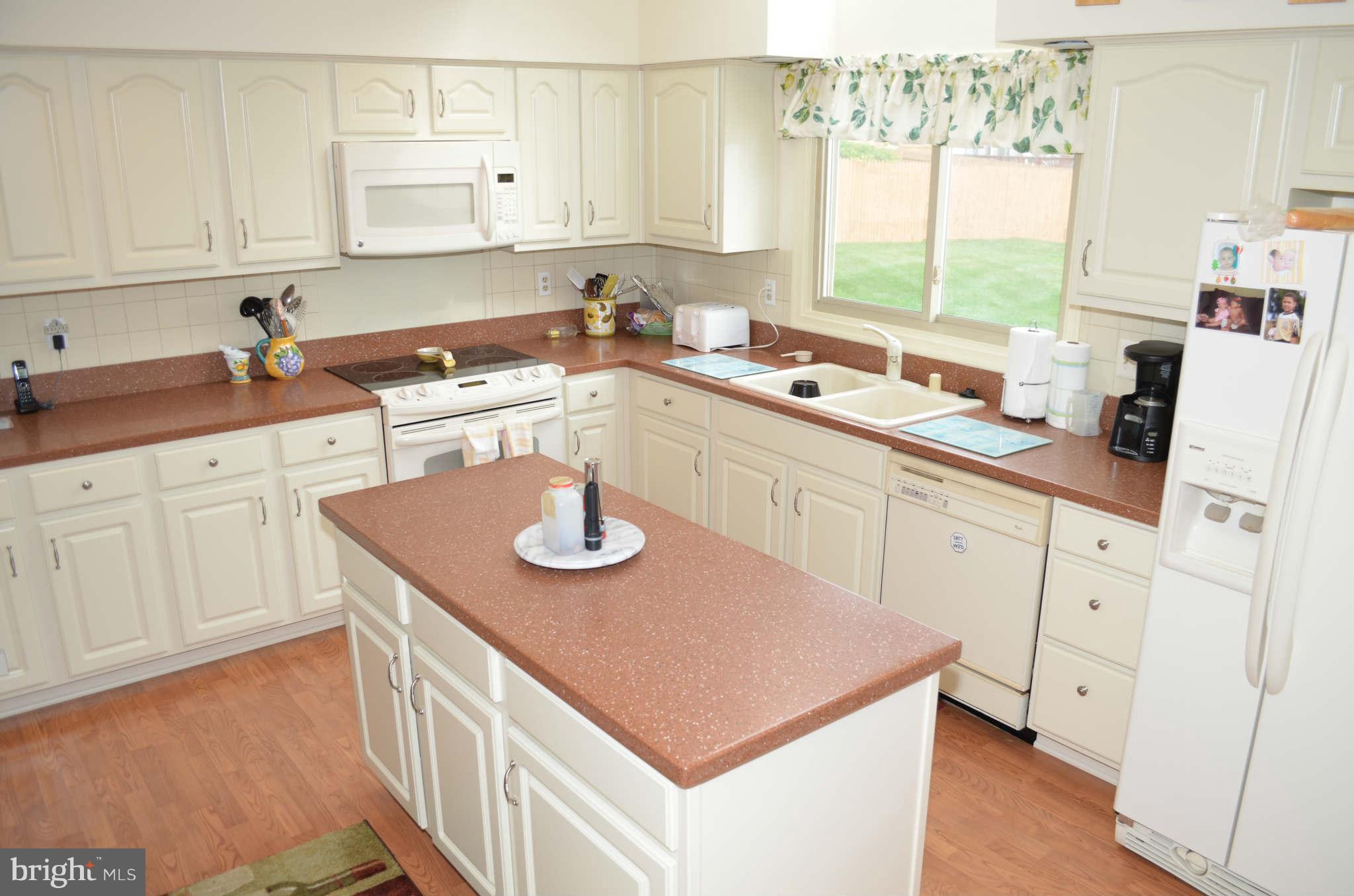 2105 Steuben Way Silver Spring, MD 20905 - Photo 7 of 10 a kitchen with a sink window and cabinets