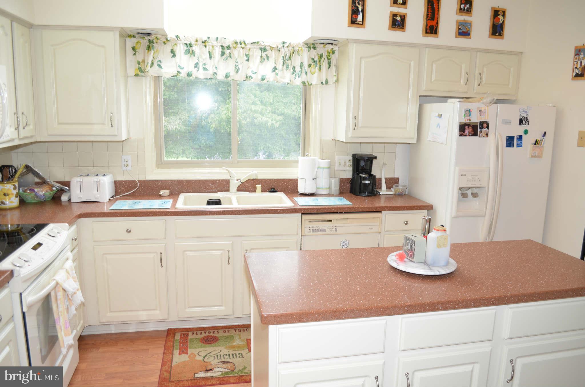 2105 Steuben Way Silver Spring, MD 20905 - Photo 8 of 10 a kitchen with a sink cabinets and window