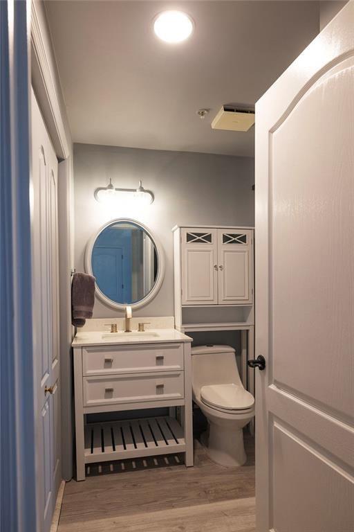 3475 Oak Valley Road Northeast, Unit 1450 Atlanta, GA 30326 - Photo 12 of 28 a bathroom with a toilet a sink and mirror